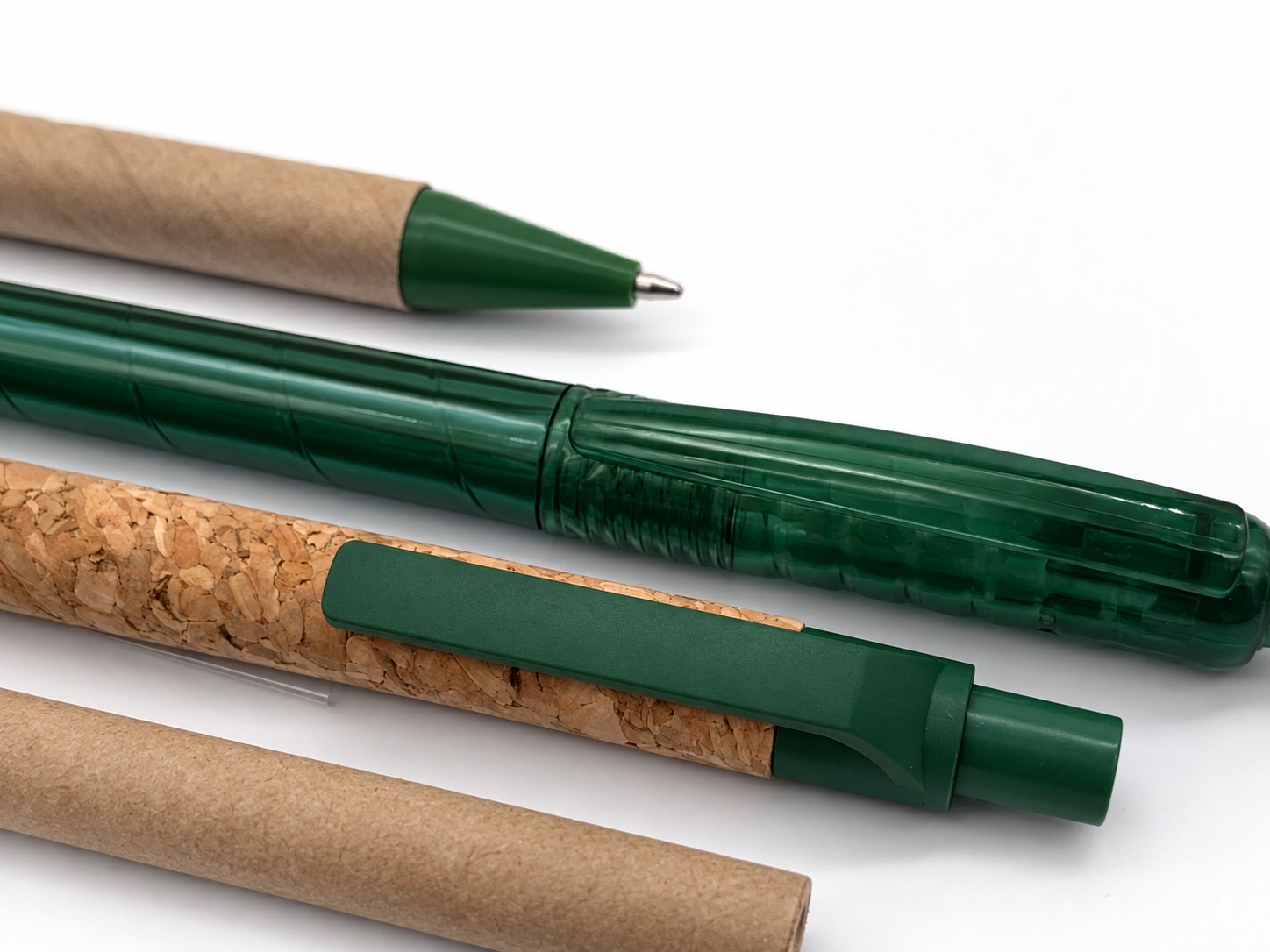 Green pens and kraft cardboard mailing tubes